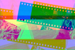 a multicolored film strip with a picture of a mountain in the background