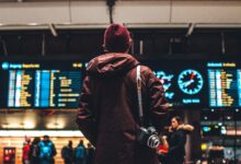 person looking up to the flight schedules