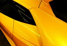 a close up of the hood of a yellow sports car