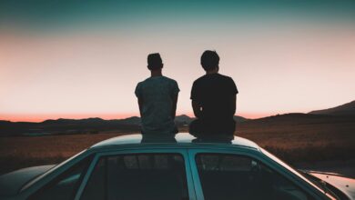 two men sitting on vehicle