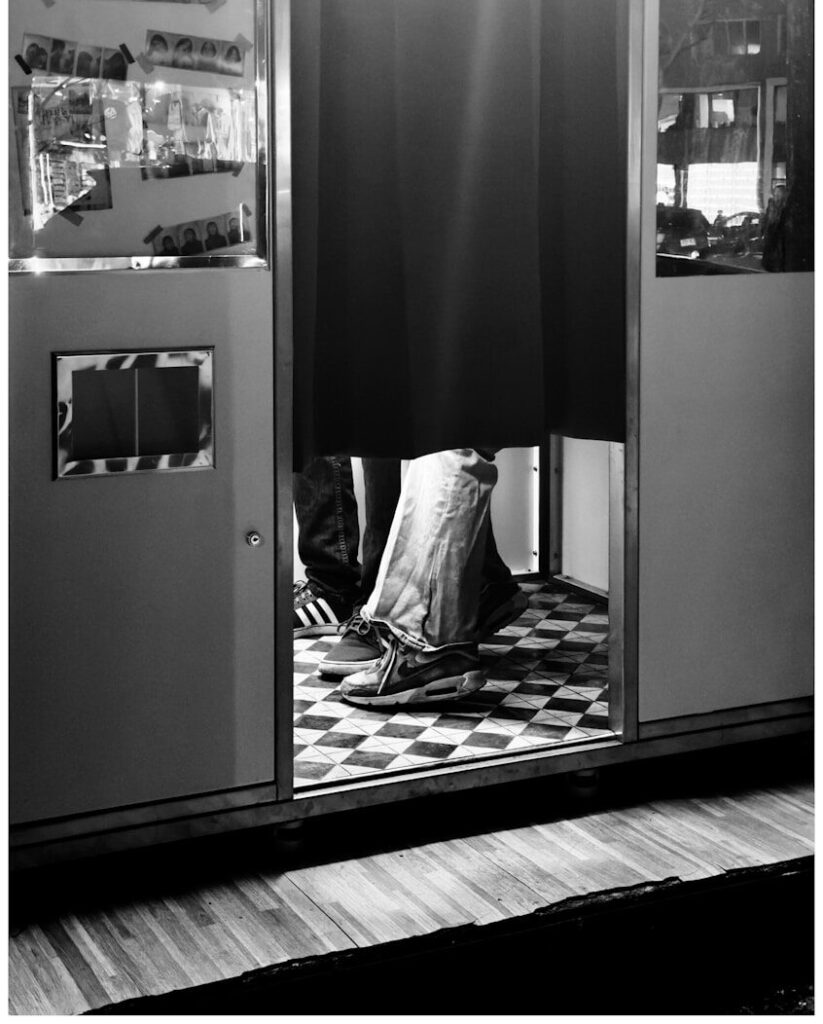 Person's legs inside a photo booth